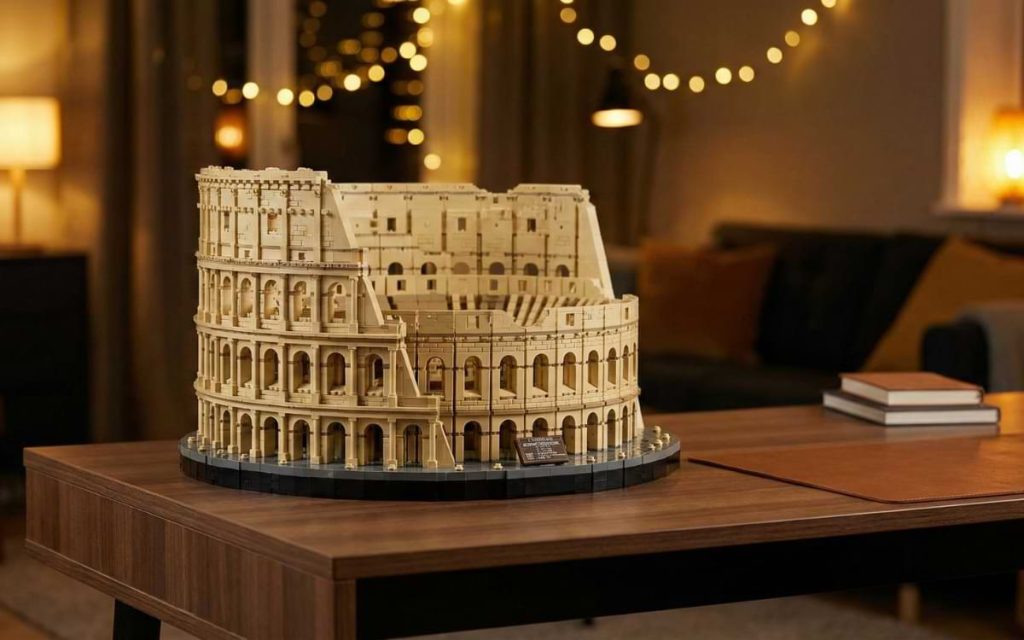 Fully built LEGO Colosseum (Set 10276) displayed on a modern wooden desk in a warm-lit living room