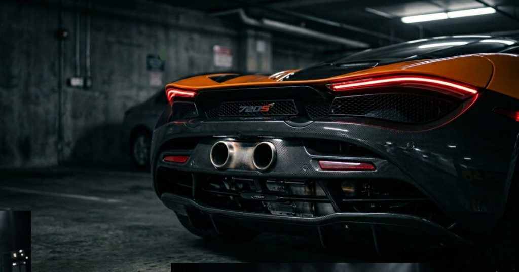 Close-up of a McLaren 720S rear end featuring thin LED taillights, twin central exhaust pipes, and a carbon-fiber diffuser in a dimly lit parking garage